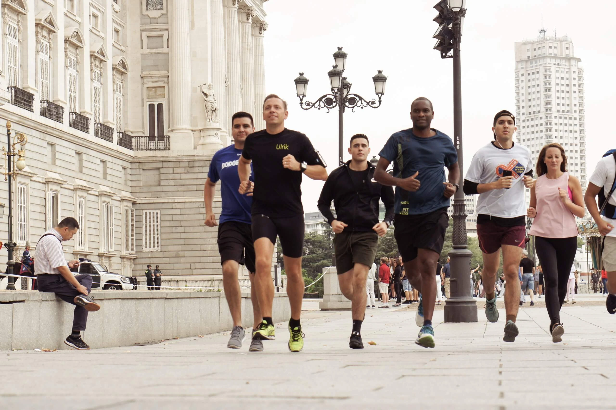 A small group running through the streets of Madrid with their local guide